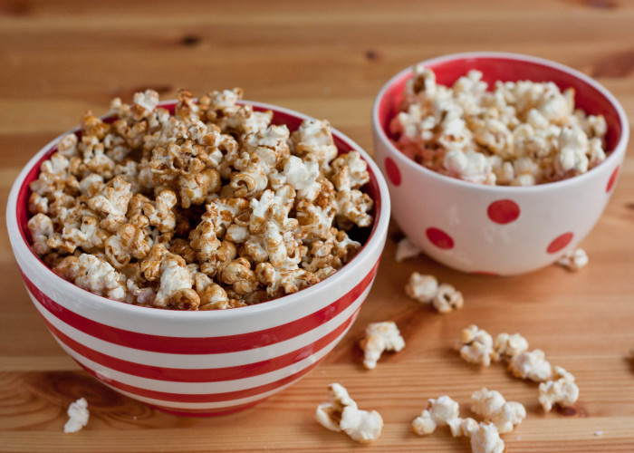 cinnamon kettle corn in a red and white striped bowl