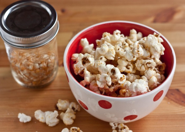 Original Kettle Corn in a bowl with un-popped popcorn kernels in a jar