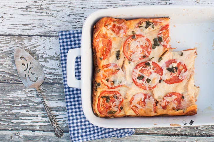 This Tomato, Basil, and Mozzarella Layered Egg Bake (Strata) is a cross between a fritatta and a bread pudding. Super cheap and you'll definitely impress your guests!