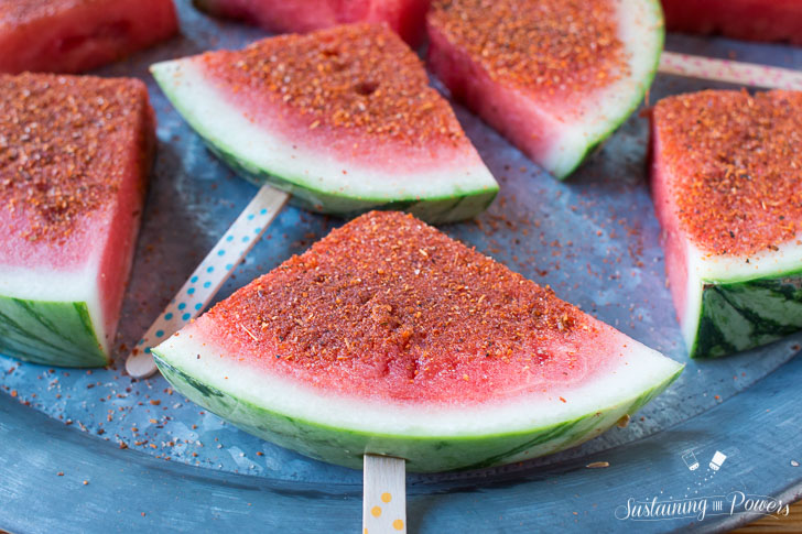 How to Make Chili Lime Watermelon Pops | These are seriously my favorite afternoon snack. You've got so many flavor profiles going on - sweet, salty, spicy, sour, and juicy watermelon. Plus it only takes about 5 minutes to put a whole pretty tray of these watermelon pops together! Click through to grab the recipe!