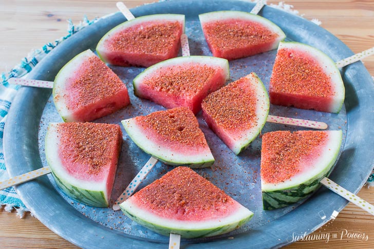 How to Make Chili Lime Watermelon Pops | These are seriously my favorite afternoon snack. You've got so many flavor profiles going on - sweet, salty, spicy, sour, and juicy watermelon. Plus it only takes about 5 minutes to put a whole pretty tray of these watermelon pops together! Click through to grab the recipe!