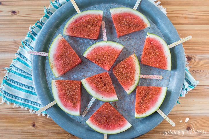 How to Make Chili Lime Watermelon Pops | These are seriously my favorite afternoon snack. You've got so many flavor profiles going on - sweet, salty, spicy, sour, and juicy watermelon. Plus it only takes about 5 minutes to put a whole pretty tray of these watermelon pops together! Click through to grab the recipe!