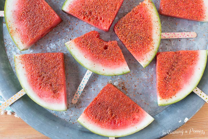 How to Make Chili Lime Watermelon Pops | These are seriously my favorite afternoon snack. You've got so many flavor profiles going on - sweet, salty, spicy, sour, and juicy watermelon. Plus it only takes about 5 minutes to put a whole pretty tray of these watermelon pops together! Click through to grab the recipe!