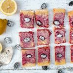 How to Make Blackberry Lemon Bars | Lemon bars are one of our favorite treats. I love the mixture of sweet and tart and a super thick shortbread crust. These have the added deliciousness of fresh blackberries that puts them totally over the top! Click through now to get the recipe!